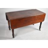 A 19th Century Mahogany Pembroke Table on Turned Caster Supports, 121cm x 56.5 x 71cm high