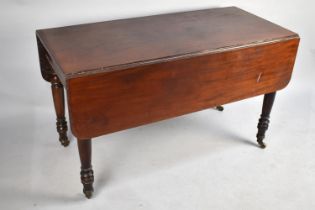 A 19th Century Mahogany Pembroke Table on Turned Caster Supports, 121cm x 56.5 x 71cm high