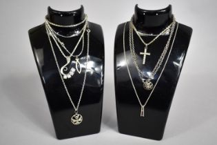 A Collection of Various and White Metal Pendants on Chains