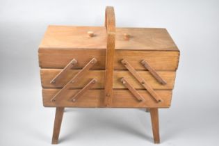 A Mid 20th Century Cantilevered Sewing Box and Contents