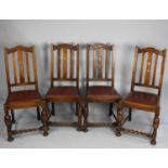 A Set of Four Oak Framed Dining Chairs with Barley Twist Supports and Bar Backs with Central Splat