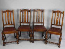 A Set of Four Oak Framed Dining Chairs with Barley Twist Supports and Bar Backs with Central Splat