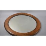 An Edwardian Circular Oak Framed Wall Mirror, 65cms Diameter