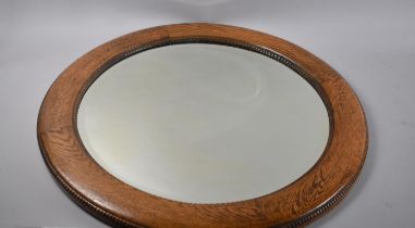 An Edwardian Circular Oak Framed Wall Mirror, 65cms Diameter