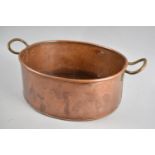 A Modern Copper Oval Pan with Two Brass Handles, 33cms Wide