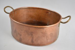 A Modern Copper Oval Pan with Two Brass Handles, 33cms Wide