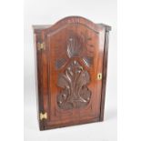 A Mid 20th Century Wooden Wall Hanging Cabinet with Carved Door Inscribed "Arms", Fitted Interior