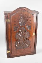 A Mid 20th Century Wooden Wall Hanging Cabinet with Carved Door Inscribed "Arms", Fitted Interior