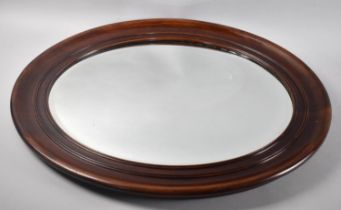 A Mahogany Framed Oval Wall Mirror with Bevel Cut Glass, 65x54cms