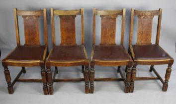 A Set of Four Mid 20th Century Oak Framed Dining Chairs with Faux Leather Pad Seats