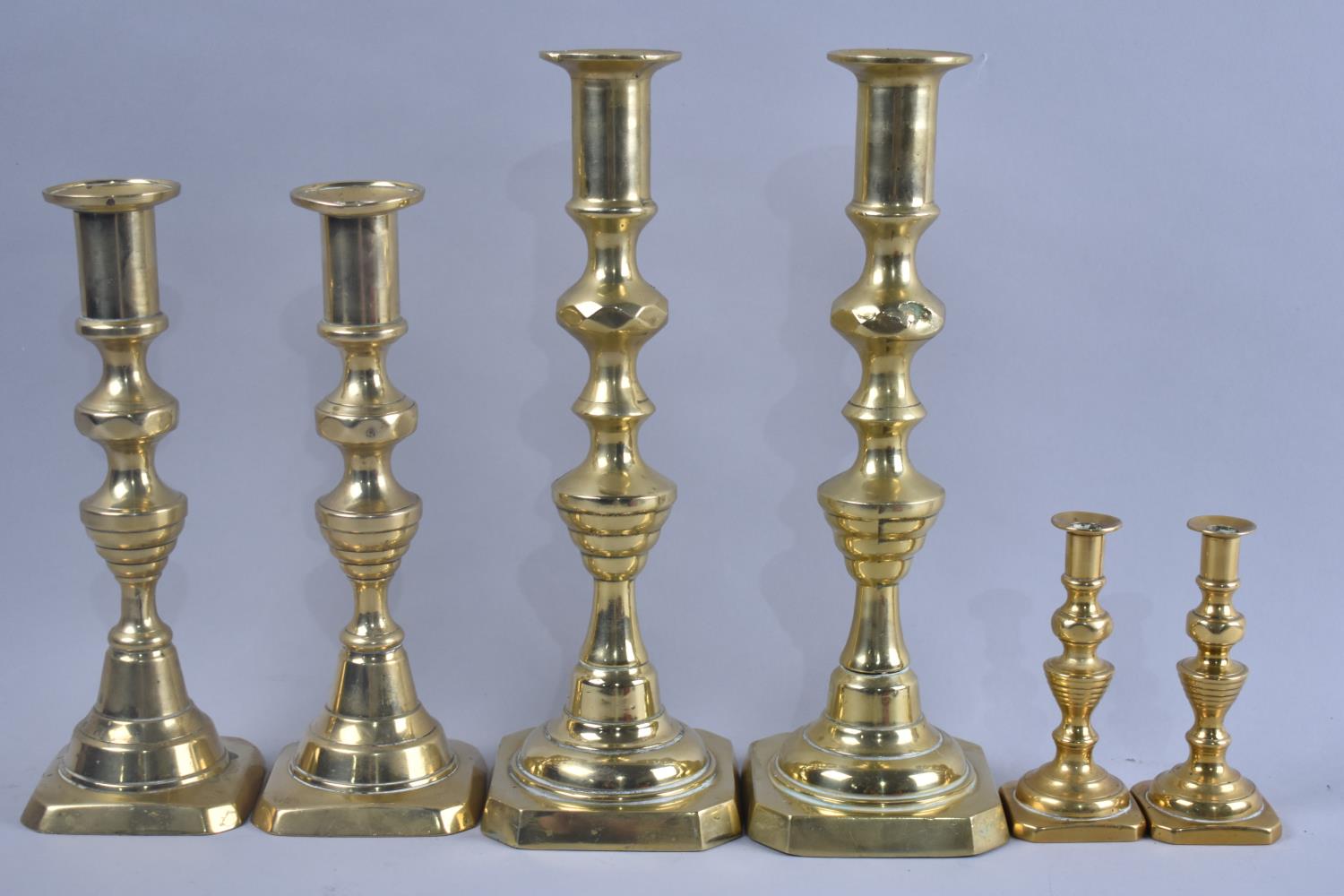 Three Pairs of Polished Brass Candlesticks, Tallest 25cms High