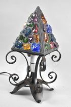 A Mid 20th century Wrought Iron and Coloured Glass Table Lamp with Pyramid Shade, 33cms High