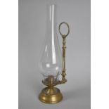 A Vintage Brass Candlestick with Ring Handle and Tall Plain Glass Chimney, 31cms High