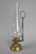 A Vintage Brass Candlestick with Ring Handle and Tall Plain Glass Chimney, 31cms High