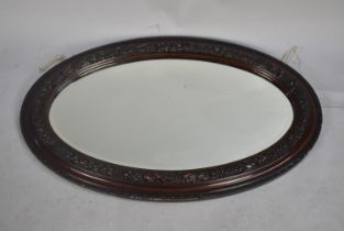 A Mid 20th Century Oval Wall Mirror in Carved Frame, 80cms Wide