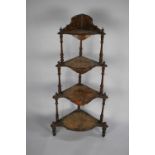 A Late Victorian Four Tier Walnut Veneered Whatnot with Turned Supports and Shaped Shells having
