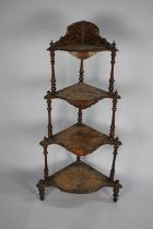 A Late Victorian Four Tier Walnut Veneered Whatnot with Turned Supports and Shaped Shells having