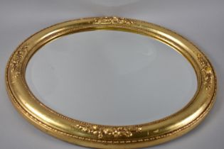 A Modern Gilt Framed Oval Wall Mirror, Some Condition Issues to Bottom Floral Moulding, 59x49cms