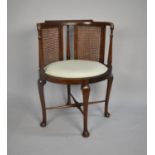 An Edwardian Oval Seated Cane Backed Armchair on Cabriole Supports