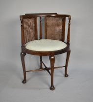 An Edwardian Oval Seated Cane Backed Armchair on Cabriole Supports