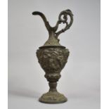 A Large Metal Continental Claret Jug, The Body Decorated in Heavy Relief Depicting Cherubs Playing