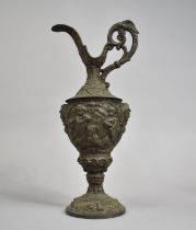 A Large Metal Continental Claret Jug, The Body Decorated in Heavy Relief Depicting Cherubs Playing