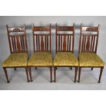 A Set of Four Art Nouveau Influenced Dining Chairs with Bar Backs and Top Blind Carved Rail on