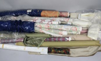 A Large Collection of Various Rolls of Fabric