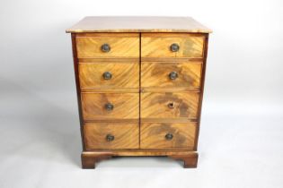 A Crossbanded Mahogany Cabinet with Pair of Doors in the Form of Four Drawer Chest, Internal