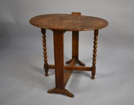 An Edwardian Oak Oval Topped Screen/Table with Bobbin Supports