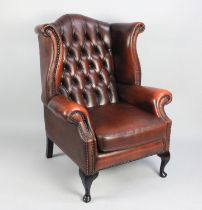 A Leather Effect Buttoned Upholstered Wing Armchair