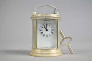 A Miniature Cylindrical Carriage Clock with White Enamelled Dial Complete with Key, 9cms High