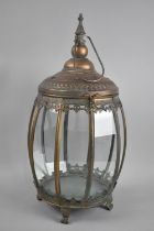 A Barrel Shaped Copper and Glass Lantern on Four Claw Feet, 47cms High