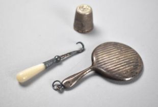 A Miniature Silver Mirror Pendant, Silver Thimble and a Mother of Pearl Handled Miniature Button