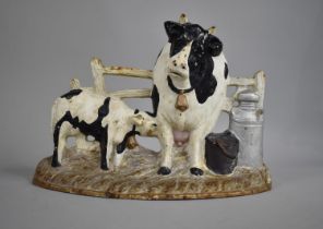 A Modern Cold Painted Cast Iron Door Stop in the Form of Cow Suckled by Calf Next to Churn, 30cms