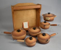 A Le Creuset Six Pan Cooking Pan Set with Stand