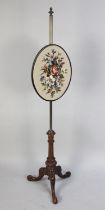 A Late 19th century Mahogany and Brass Rise and Fall Pole Screen with Oval Panel having Floral