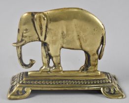A Late Victorian Brass Fireside Ornament in the Form of an Elephant, 12.5cms Wide