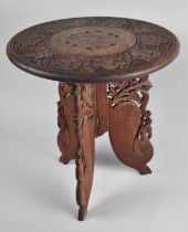 A Carved Circular Topped Indian Occasional Table with Folding Triform Base, 38cms Diameter,