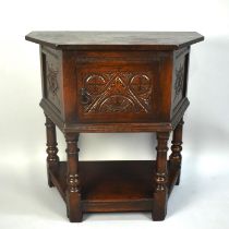 A Mid 20th Century Oak Credence Table with Carved Hinged Front Door and Side Panels, Turned Supports