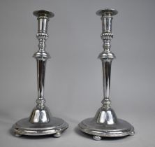 A Pair of Silver Plated Candlesticks on Circular Bases with Four Bun Feet, 26cms High