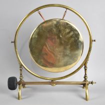 A Late Victorian/Edwardian Circular Brass Table Gong with Clapper, 34cms High