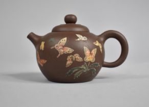 A Chinese Yixing Teapot Decorated with Applied Enamels Detailing Butterflies and Flowers, 7cms High