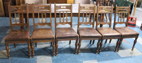 A Set of Six Edwardian Carved Oak Leather Seated Dining Chairs