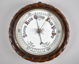An Edwardian Oak Framed Circular Aneroid Barometer with White Enamelled Dial and Carved Rope Border,