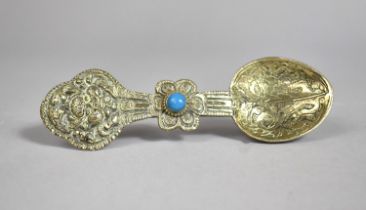 A Far Eastern White Metal Anointing Spoon with Pale Blue Cabochon and Engraved and Relief