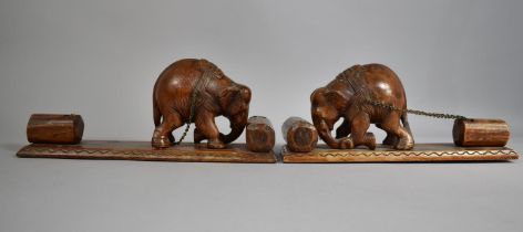 A Pair of Carved Wooden Indian Book Ends in the Form of Elephants Pushing Tree Trunk Whilst Dragging