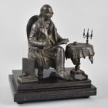 A Bronze Effect Spelter Figure of a Seated Academic Beside Tripod Table with Candelabra Holding Book