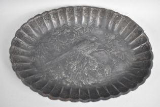 A Japanese Pressed Metal Oval Dish with Relief Decoration in the Form of Pheasants and Flowers, Wavy