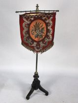 A Victorian Aesthetic Movement Polescreen with Beadwork Shield Shaped Banner Upon Brass Pole